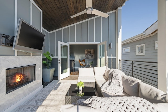 view of patio / terrace with ceiling fan and exterior fireplace