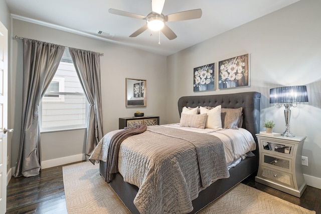 bedroom with dark hardwood / wood-style floors and ceiling fan