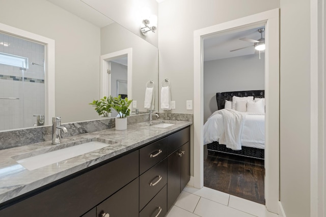 bathroom with tile patterned flooring, vanity, ceiling fan, and walk in shower