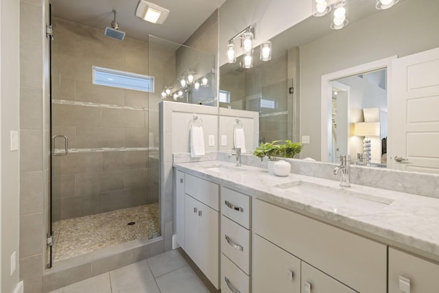 bathroom featuring tile patterned flooring, vanity, and an enclosed shower