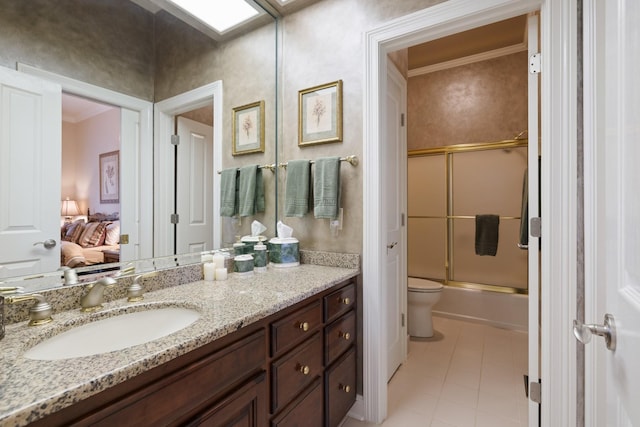 bathroom with vanity, combined bath / shower with glass door, ornamental molding, and tile patterned floors