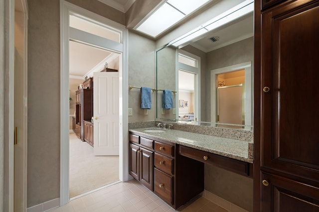 bathroom featuring vanity, crown molding, and walk in shower