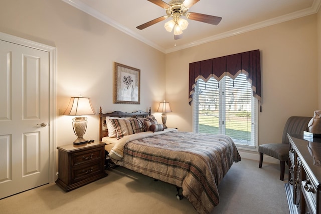 carpeted bedroom with ceiling fan and ornamental molding