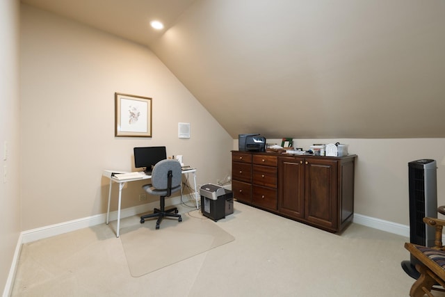 office area featuring light carpet and vaulted ceiling