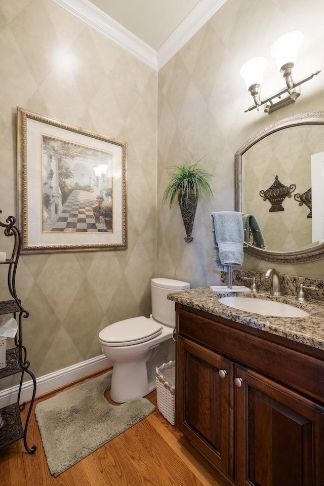 bathroom featuring crown molding, vanity, toilet, and hardwood / wood-style floors