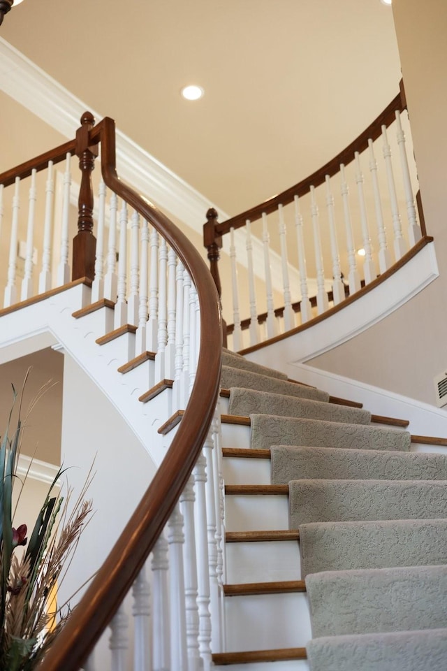 stairs featuring crown molding