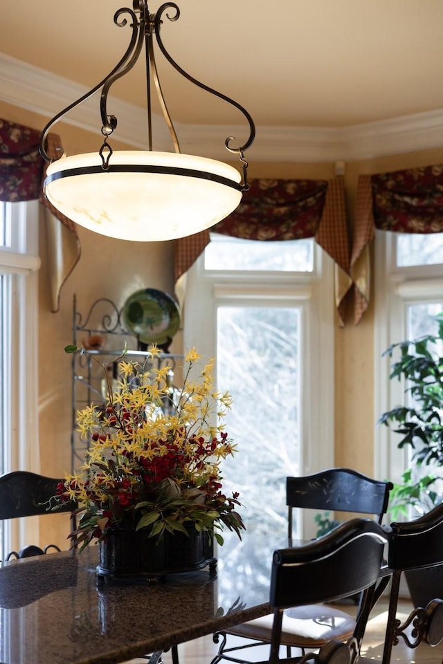 dining space featuring crown molding