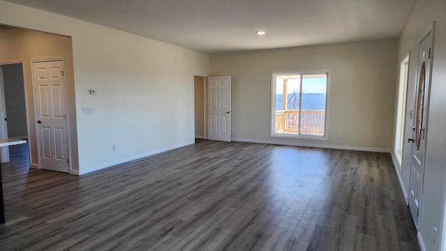 spare room featuring dark wood-type flooring