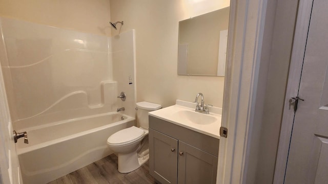 full bathroom featuring toilet, shower / washtub combination, wood-type flooring, and vanity