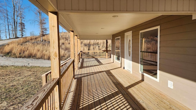 wooden terrace featuring covered porch