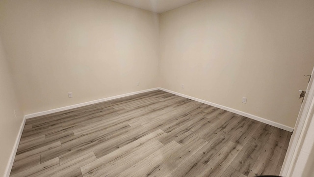 unfurnished room with light hardwood / wood-style floors