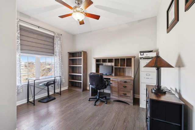 home office with dark wood-type flooring and ceiling fan