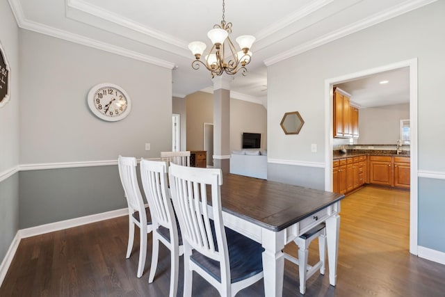 dining area featuring an inviting chandelier, ornamental molding, and hardwood / wood-style floors