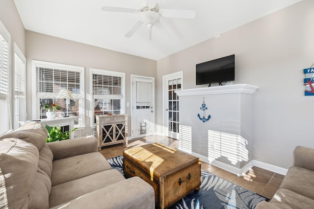 living room featuring ceiling fan and tile patterned floors