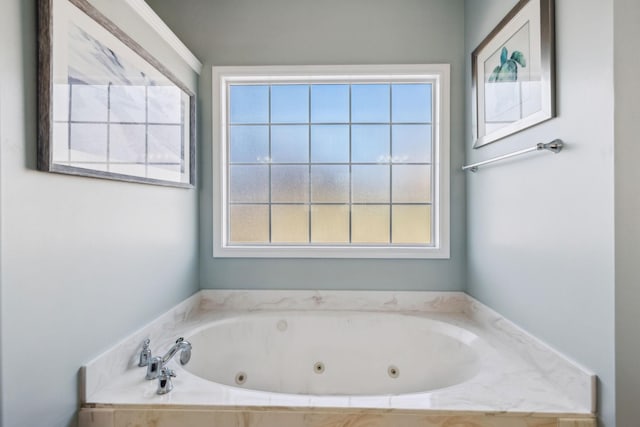 bathroom with a relaxing tiled tub