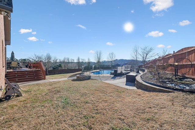 view of yard with a pool side deck