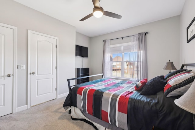 bedroom with ceiling fan and light colored carpet