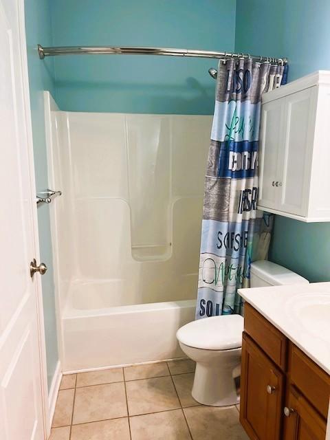 full bathroom with toilet, vanity, tile patterned flooring, and shower / bath combo