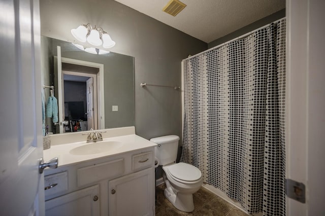 bathroom with a textured ceiling, tile patterned flooring, vanity, a shower with curtain, and toilet