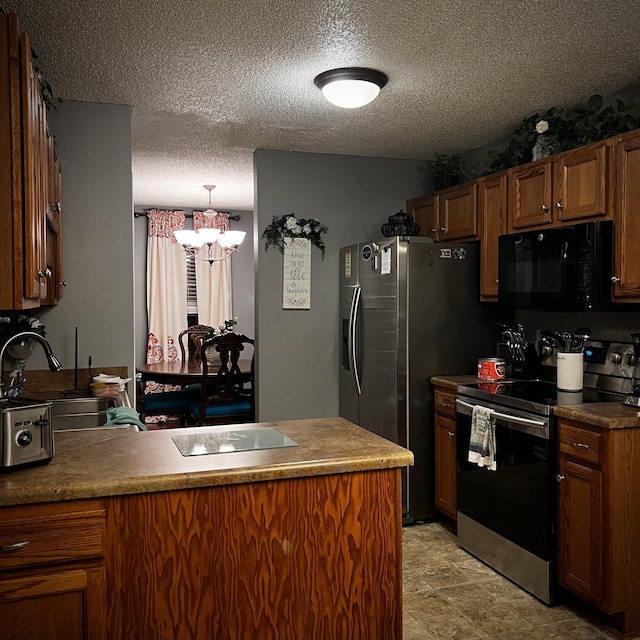 kitchen with sink, stainless steel appliances, a chandelier, and a textured ceiling