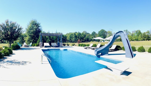 view of pool with a water slide, a pergola, a patio, and a diving board