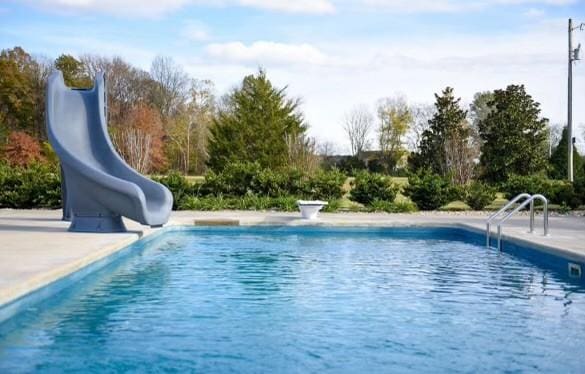 view of swimming pool with a water slide