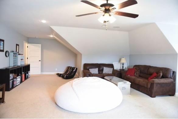 interior space with lofted ceiling, ceiling fan, and carpet