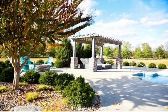 view of community featuring a pool, a patio, and a pergola