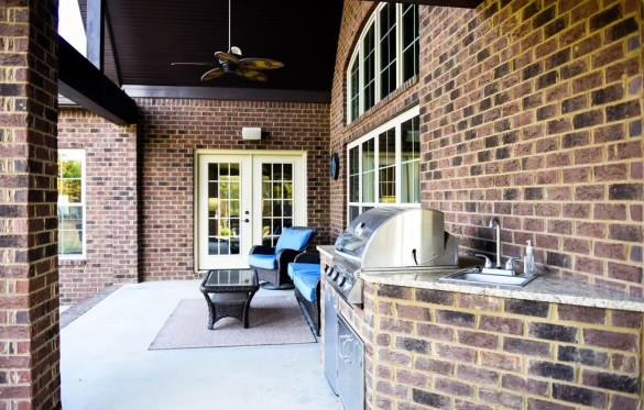 view of patio with french doors, sink, area for grilling, ceiling fan, and a grill