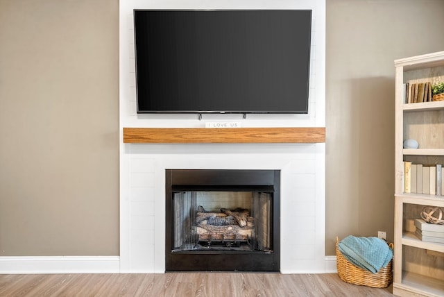 interior details with a large fireplace and hardwood / wood-style floors