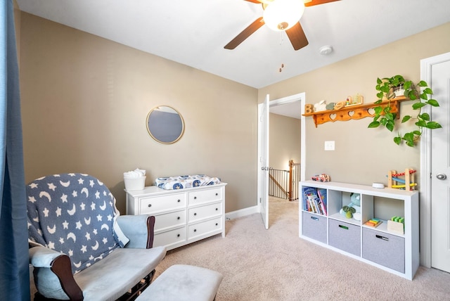 sitting room featuring ceiling fan and light colored carpet