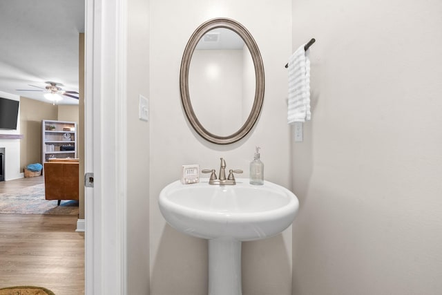 bathroom featuring hardwood / wood-style floors, ceiling fan, and sink