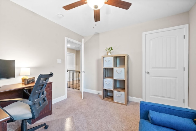 office area featuring light carpet and ceiling fan