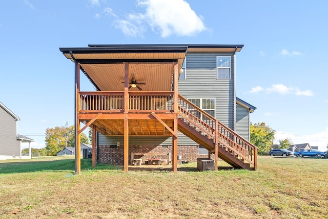 rear view of house with a yard, a deck, ceiling fan, and cooling unit