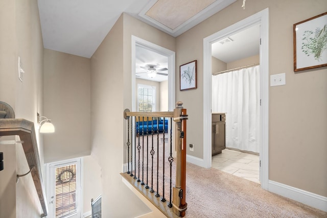 hallway featuring light colored carpet