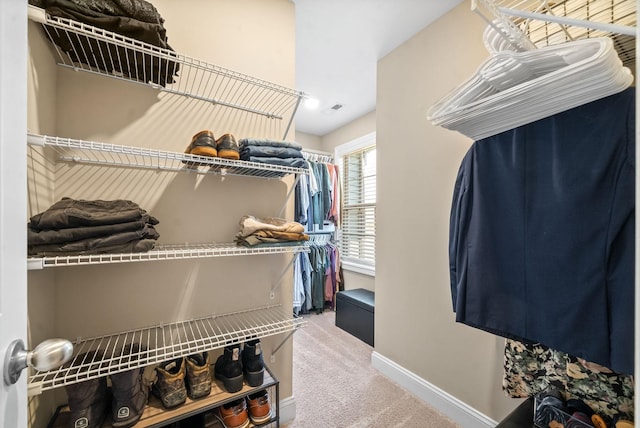 walk in closet featuring carpet floors