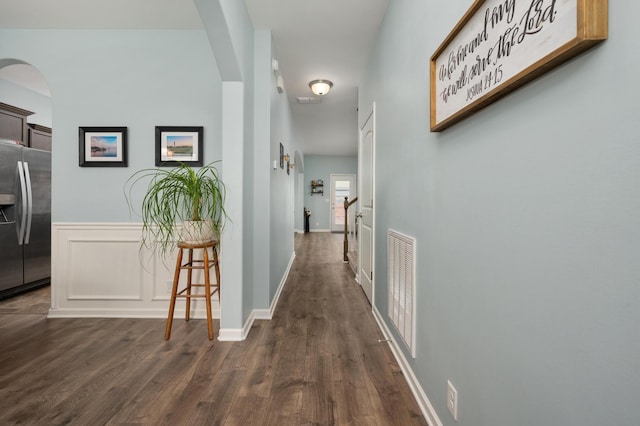 corridor with dark hardwood / wood-style flooring