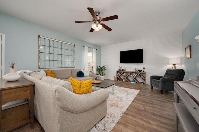 living room with ceiling fan and dark hardwood / wood-style flooring