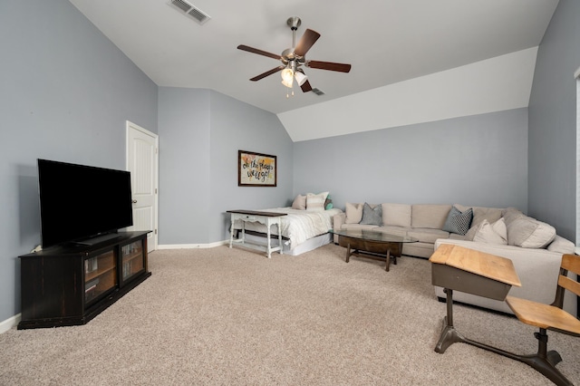 carpeted living room with ceiling fan and vaulted ceiling