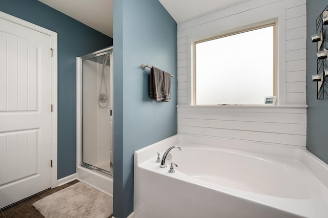 bathroom featuring shower with separate bathtub and plenty of natural light