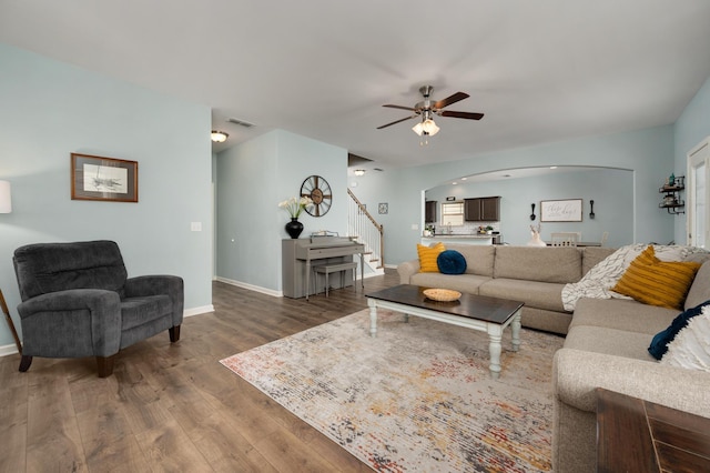 living room featuring hardwood / wood-style floors and ceiling fan