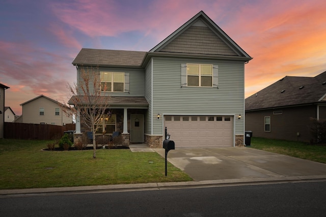 view of front property featuring a lawn and a garage