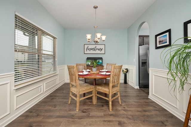 dining space featuring dark hardwood / wood-style flooring and a chandelier