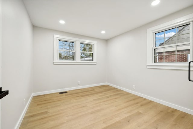 spare room featuring light hardwood / wood-style floors