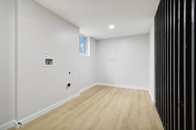 laundry room with electric dryer hookup, hookup for a washing machine, and light hardwood / wood-style flooring