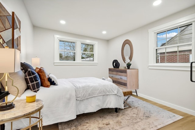 bedroom featuring hardwood / wood-style flooring and multiple windows