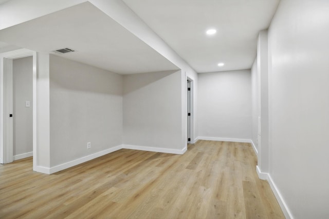 basement with light hardwood / wood-style flooring