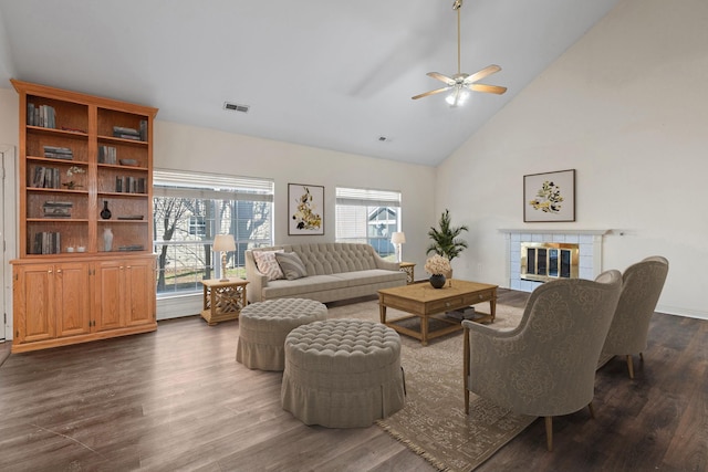 living room with dark hardwood / wood-style flooring, a fireplace, high vaulted ceiling, and ceiling fan