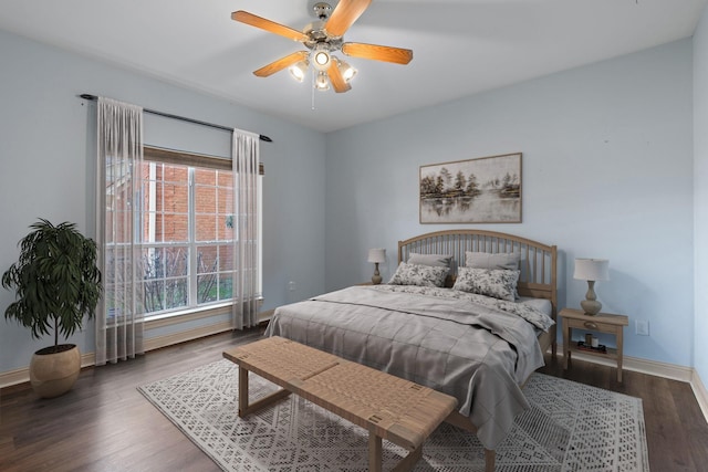 bedroom with ceiling fan and dark hardwood / wood-style flooring