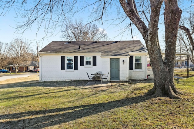 view of front facade with a patio and a front lawn